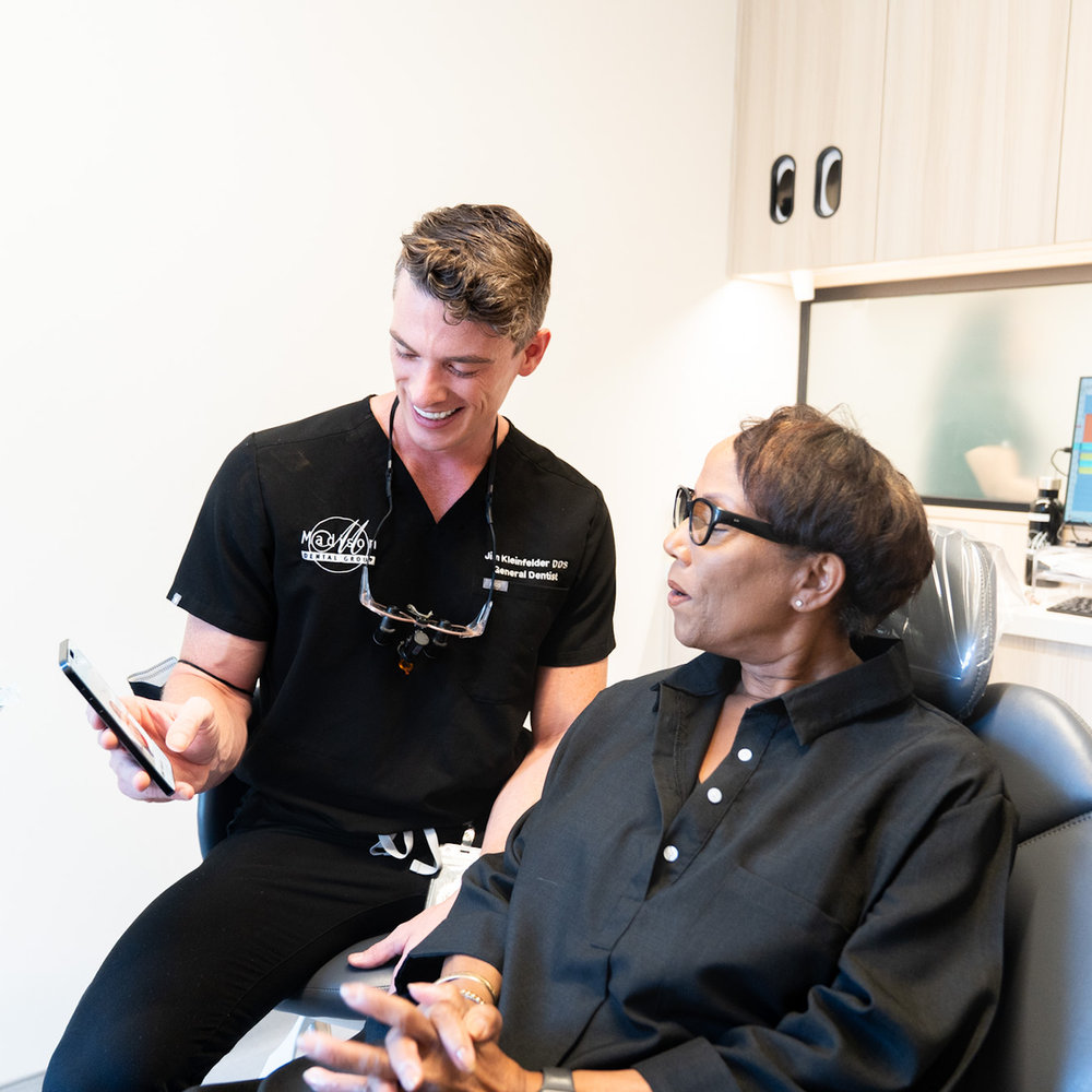 A Madison Dental Group dentist discussing treatment with a patient.